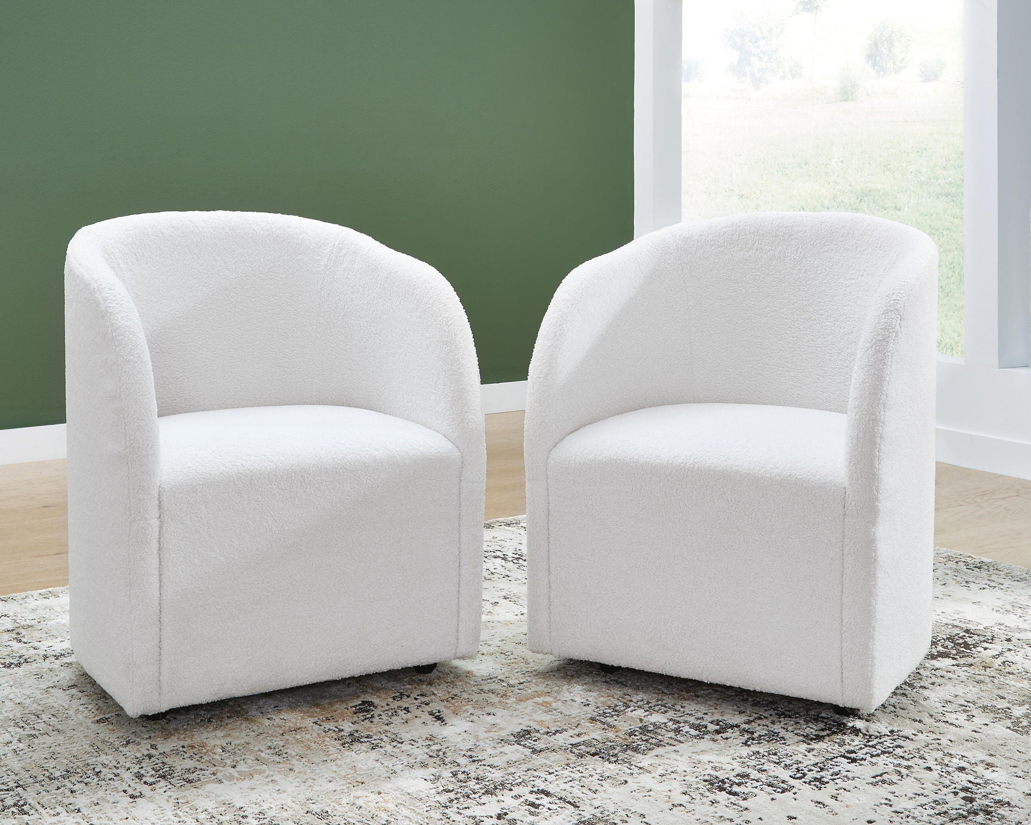 Upholstered dining arm chairs, ivory fabric, rounded back and arms, tapered legs