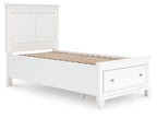 White panel bed frame with open slatted base and two panel doors on the headboard