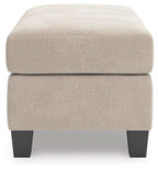 Taupe upholstered ottoman with smooth fabric and thick seat top, dark legs