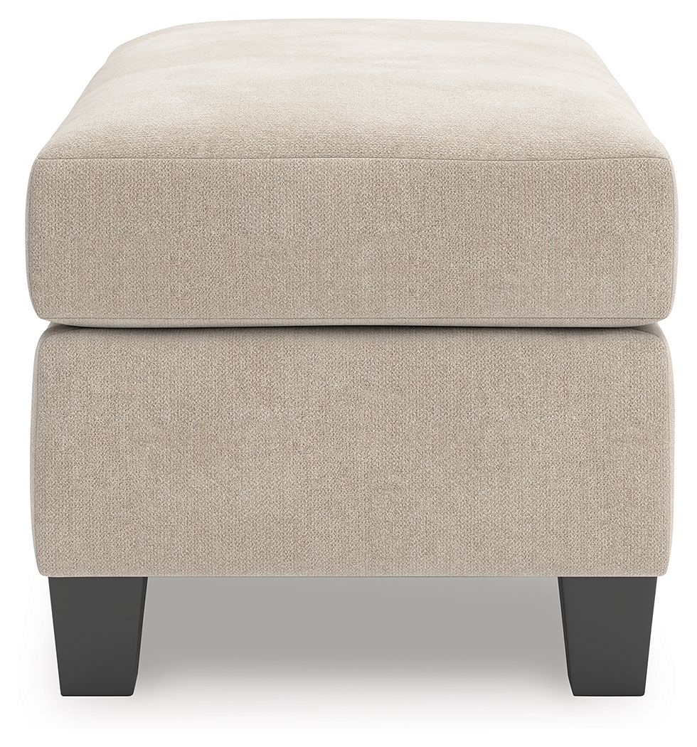 Taupe upholstered ottoman with smooth fabric and thick seat top, dark legs