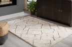 Gray geometric lattice rug laid on hardwood floor