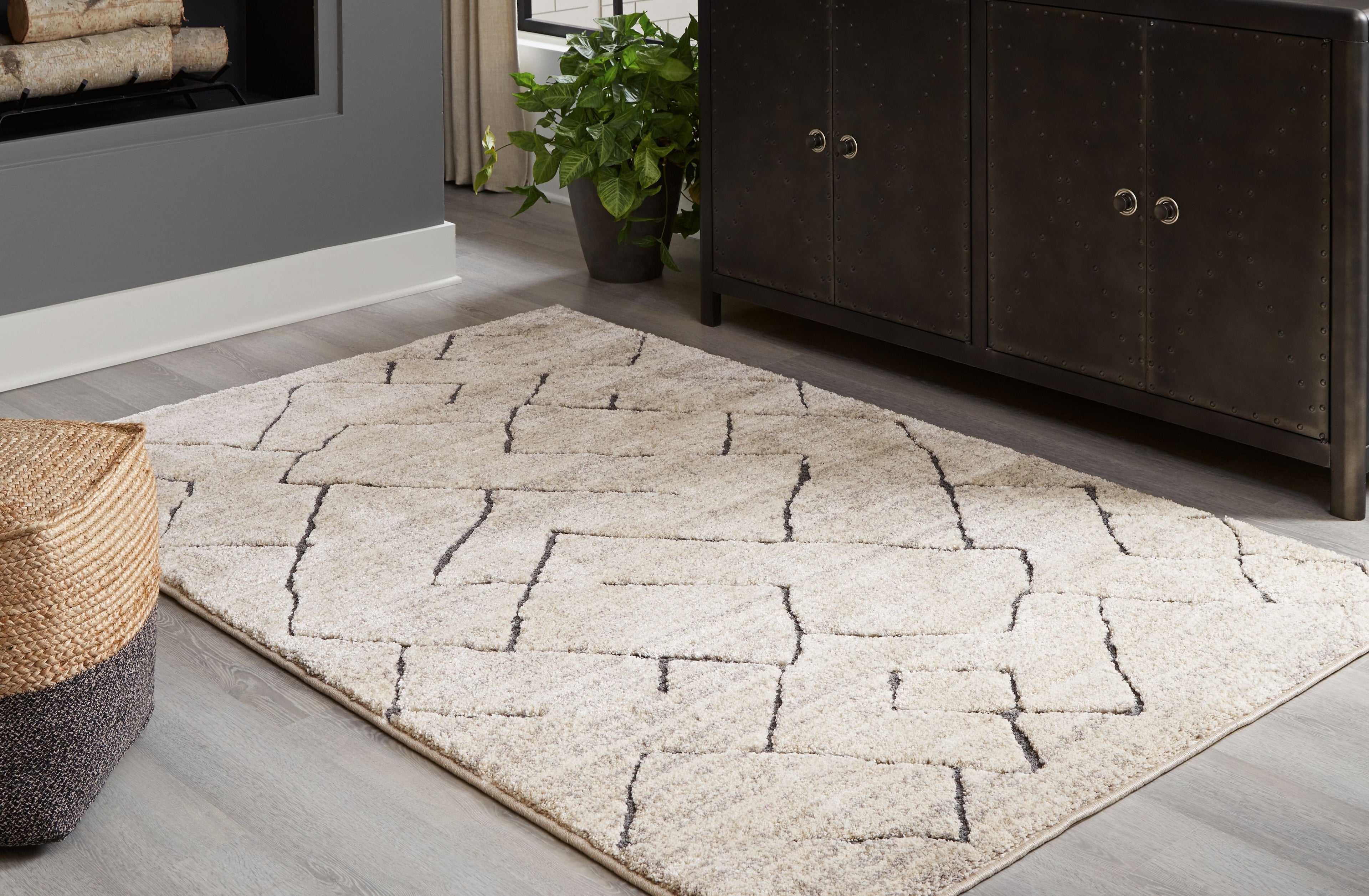 Gray geometric lattice rug laid on hardwood floor