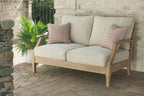 Beige loveseat with cushion and two patterned throw pillows