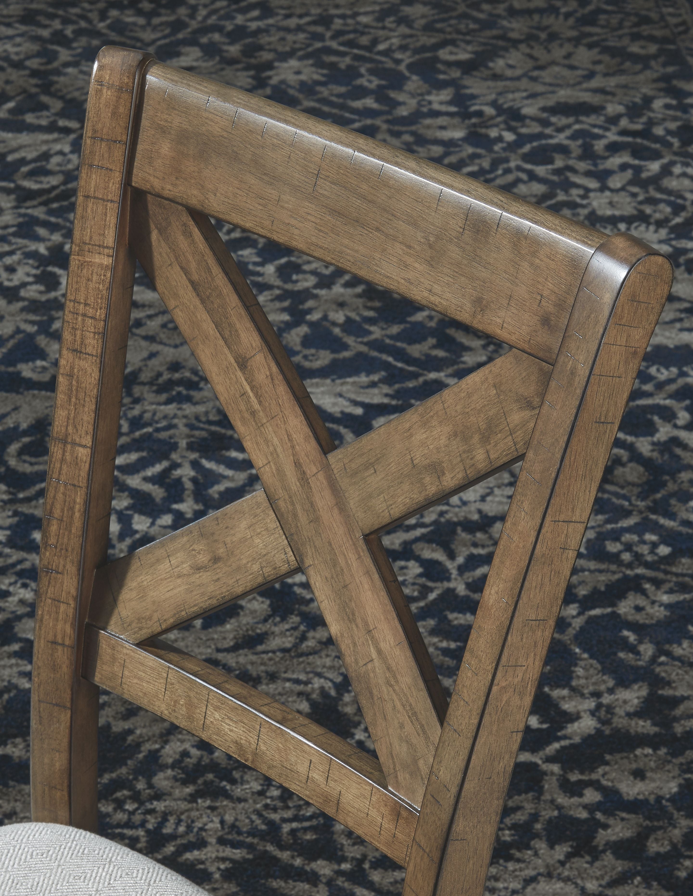 Upholstered dining chair back with dark wood frame and X-cross brace.
