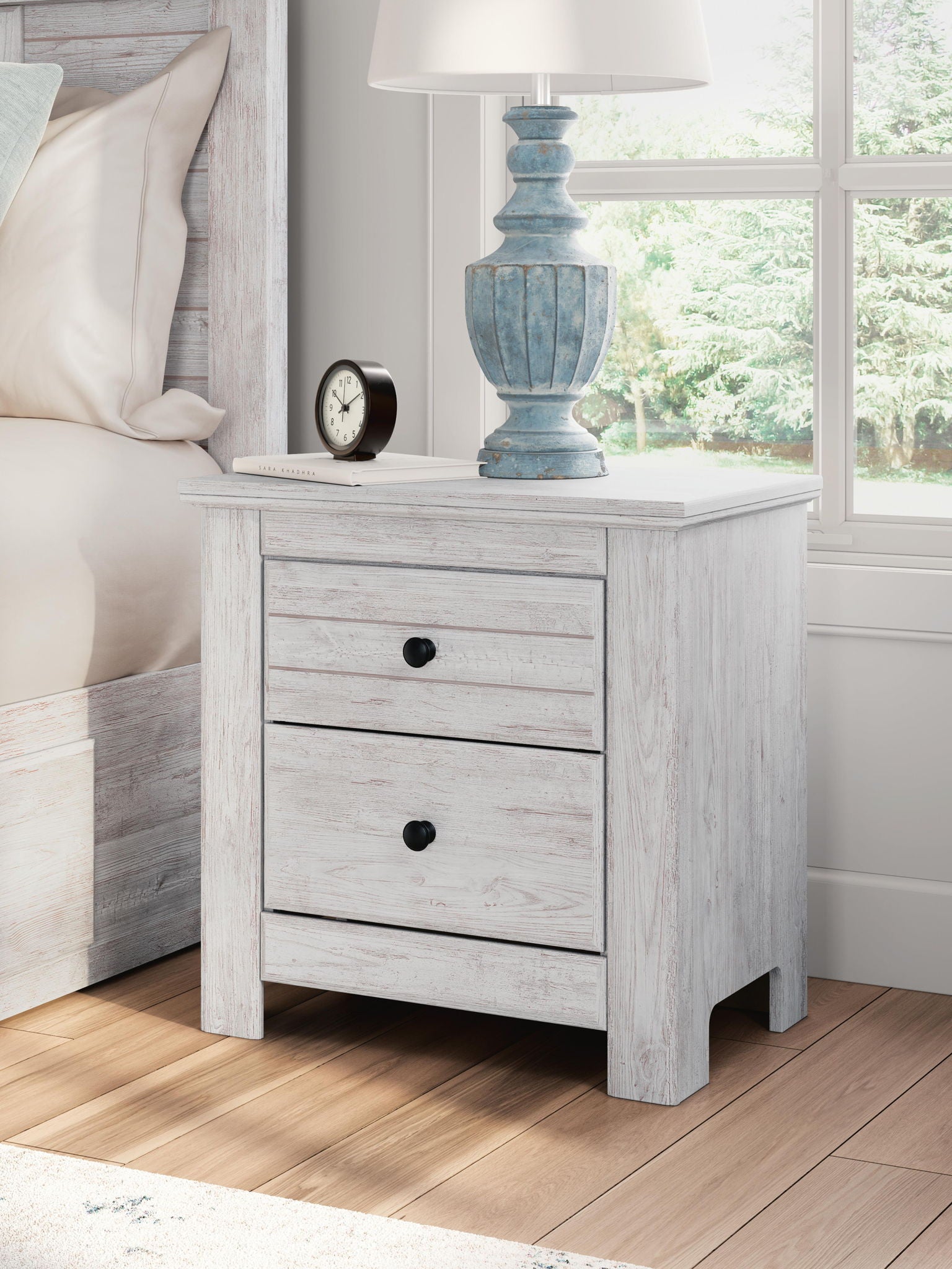 White two-drawer night stand with black round knob pulls