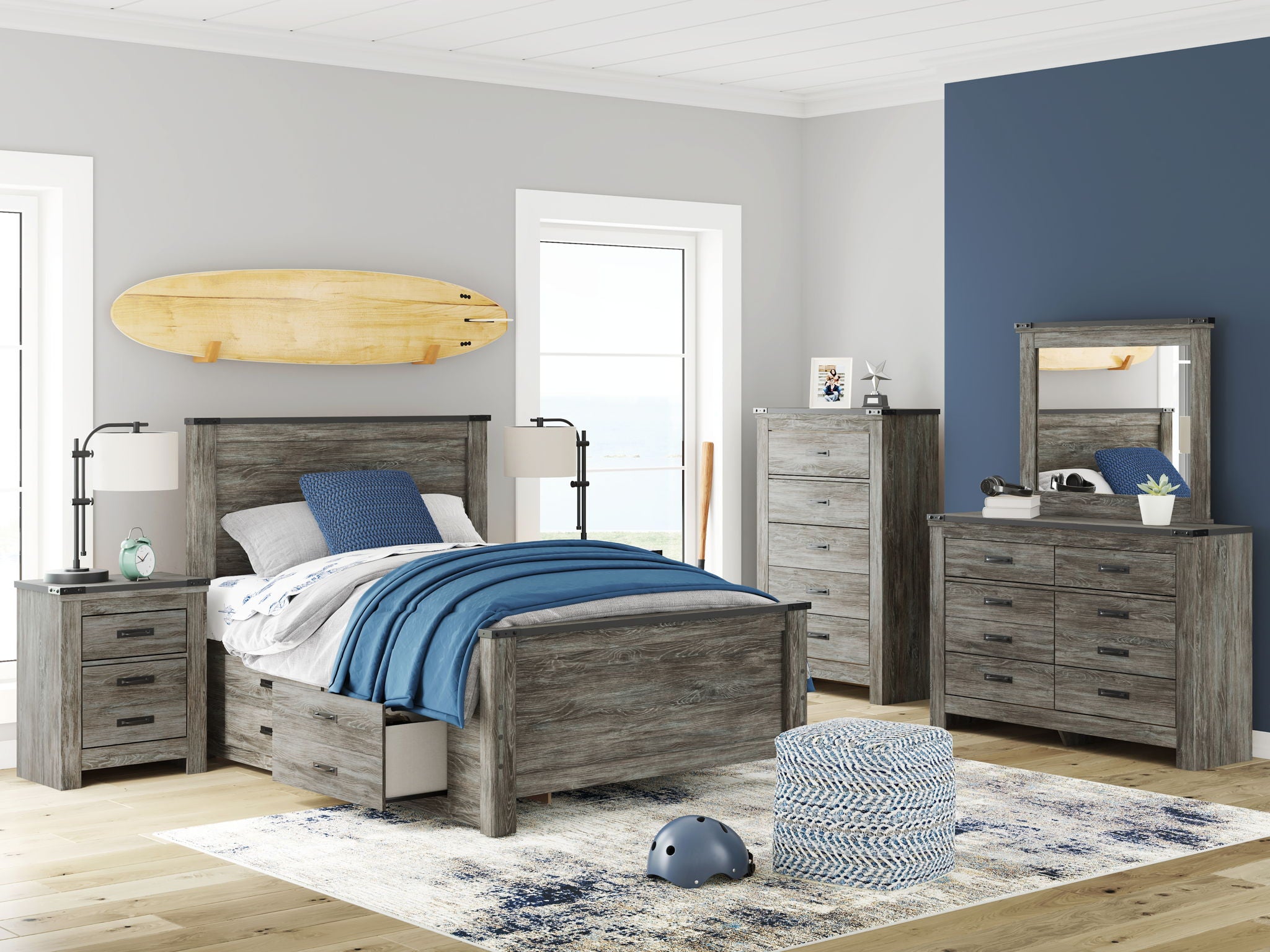 Gray bedroom storage set with bed, dresser, and mirror in a staged room
