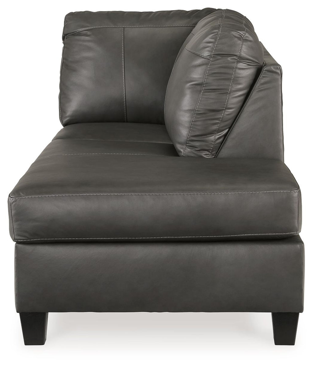 Fog gray leather corner chaise with padded backrest, rounded arm, and square feet.