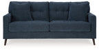 Navy blue fabric sofa with split seat cushions and four back pillows