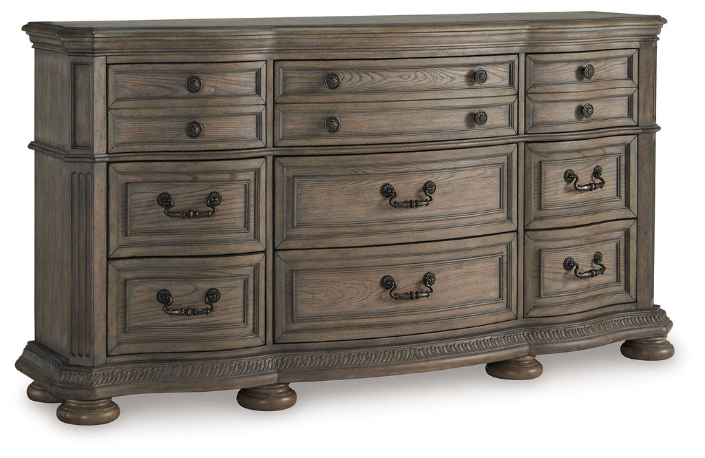 Light brown wood dresser with multiple drawers and black knob handle pulls