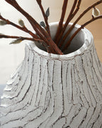 White vase top opening with carved vertical ridges and decorative branches