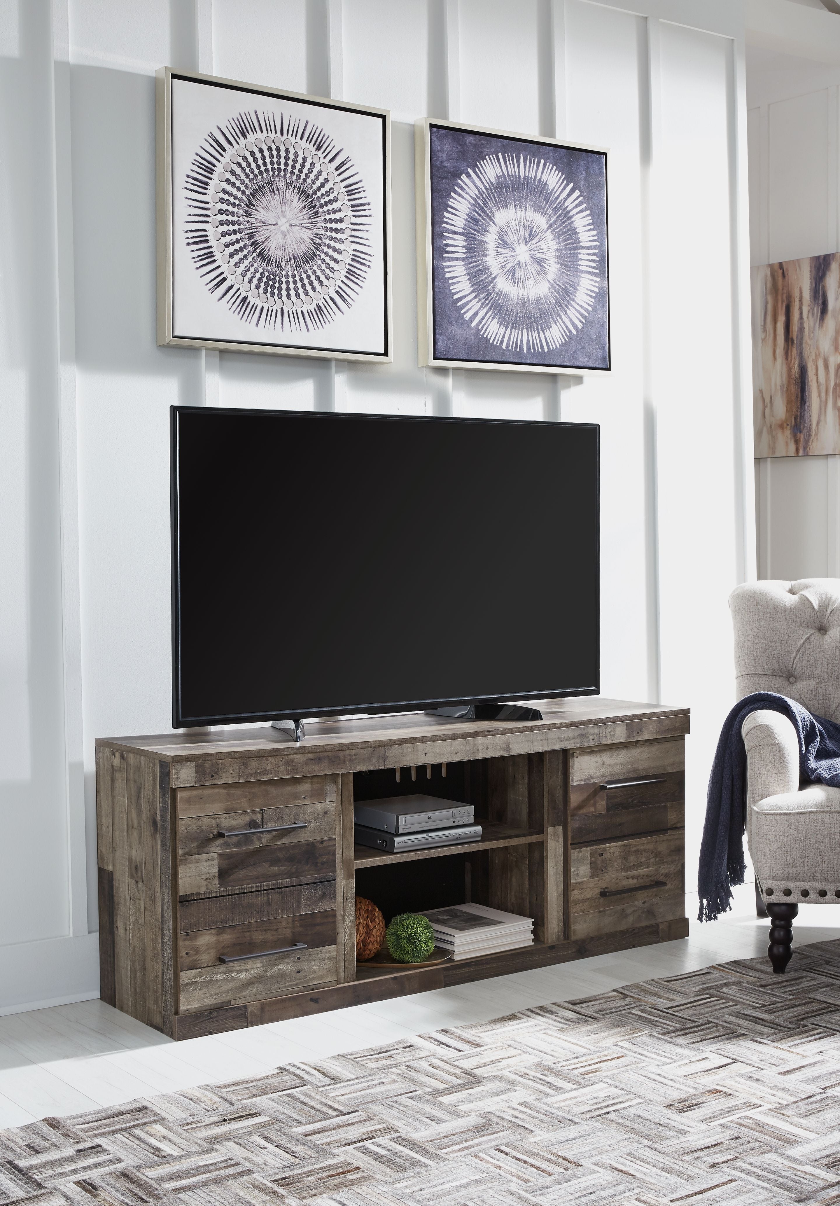Gray TV stand with open center shelves and storage drawers for media devices