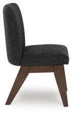 Upholstered dining side chair viewed from side, dark fabric seat and back, brown legs