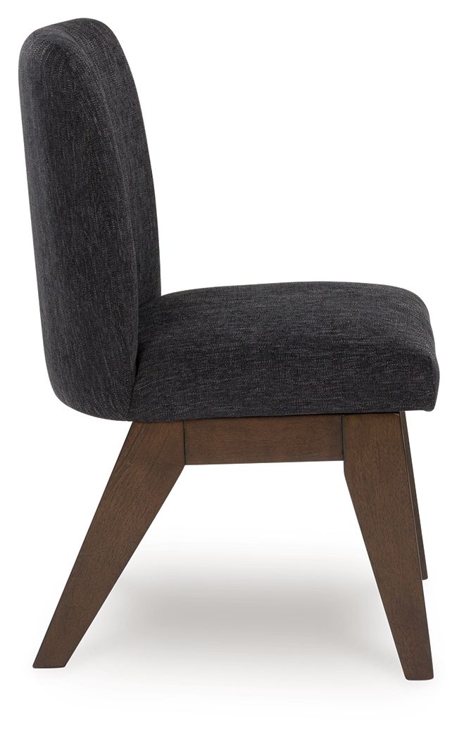 Upholstered dining side chair viewed from side, dark fabric seat and back, brown legs