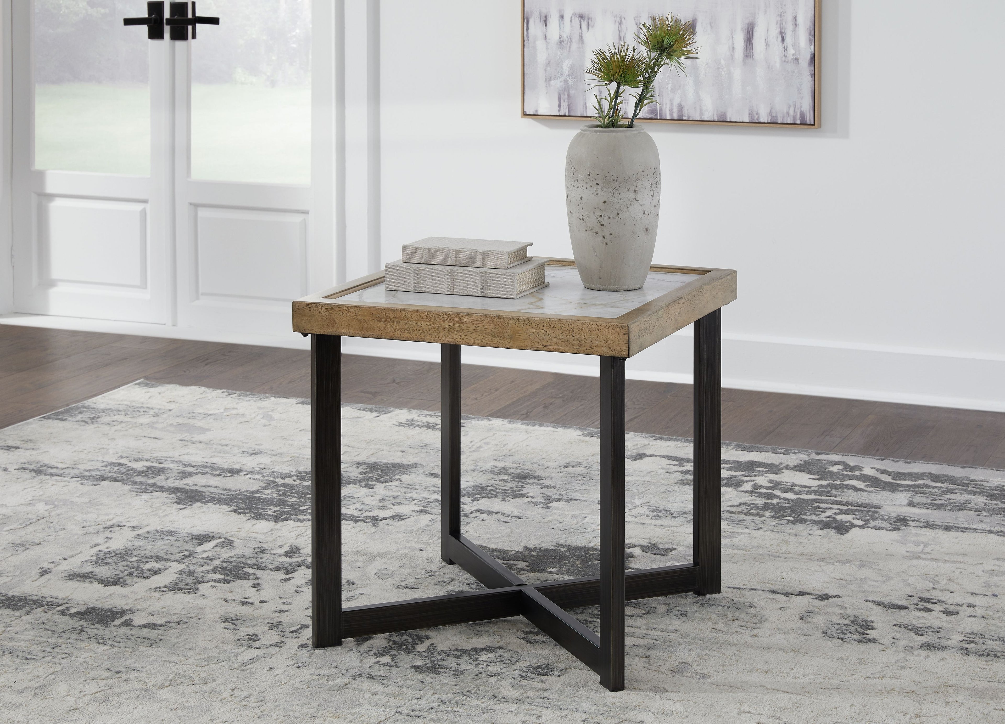 Square end table with light stone-look top, dark wood legs, with books and vase