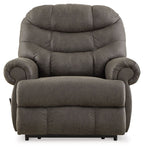 Gunmetal recliner chair with high back, rounded armrests, and padded footrest.