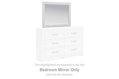 Whitewash bedroom mirror with rectangular frame, shown above a dresser
