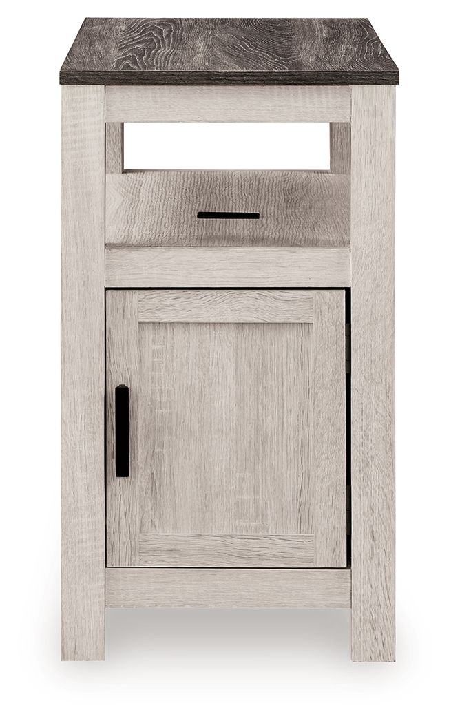 Chair side end table with open shelf and single door cabinet, light wood finish, black pulls.
