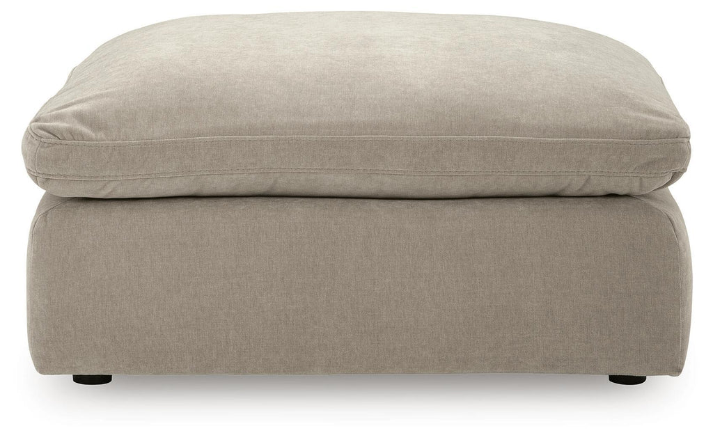 Oversized accent ottoman in light gray, front view with thick cushion and legs