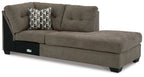 Chocolate-brown corner chaise with tufted back, seat cushion, and patterned throw pillow