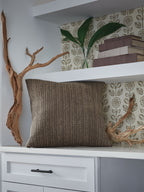 Dark brown textured throw pillow with vertical woven stripe pattern