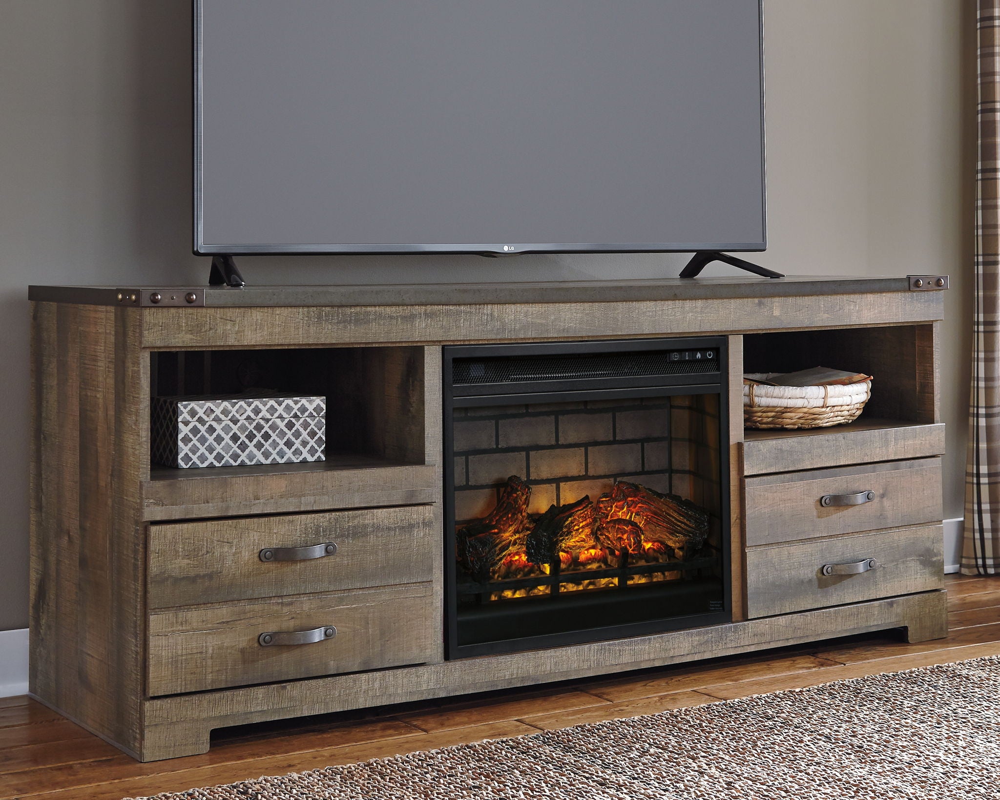 Brown wood TV stand with fireplace insert, media shelf, and two center drawers