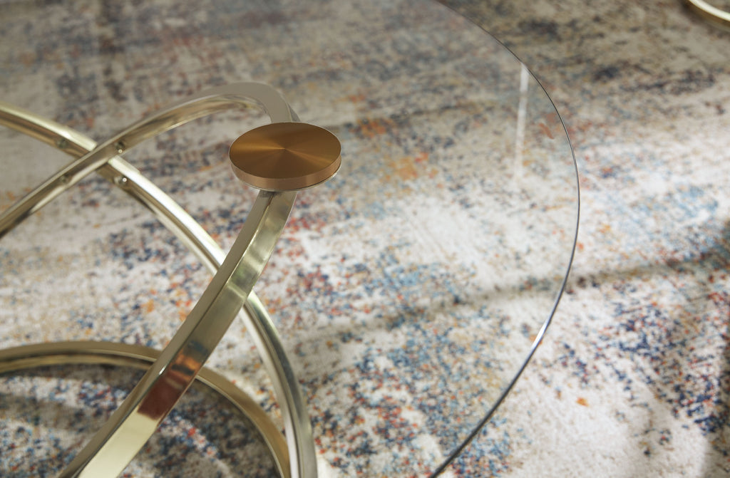 Glass tabletop edge with champagne metal frame and rounded base detail
