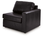 Black right-arm corner armchair with padded seat, armrests, and back pillow