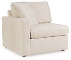 Corner chair with tall back cushion, light beige upholstery, and wide seat with armrests