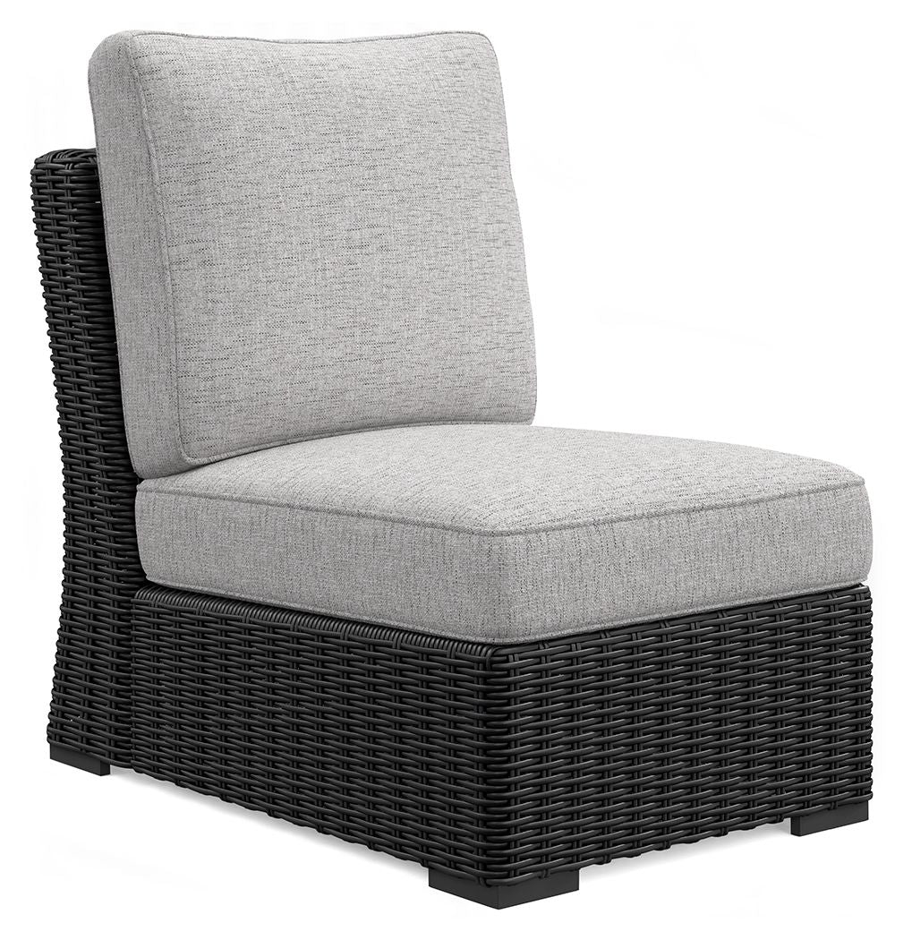Light gray armless chair with cushion on black woven wicker base