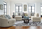 Beige sectional corner chaise sofa with patterned pillows and multiple matching chaise seats
