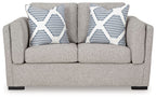 Gray loveseat sofa with two white-and-blue striped throw pillows on the backrest