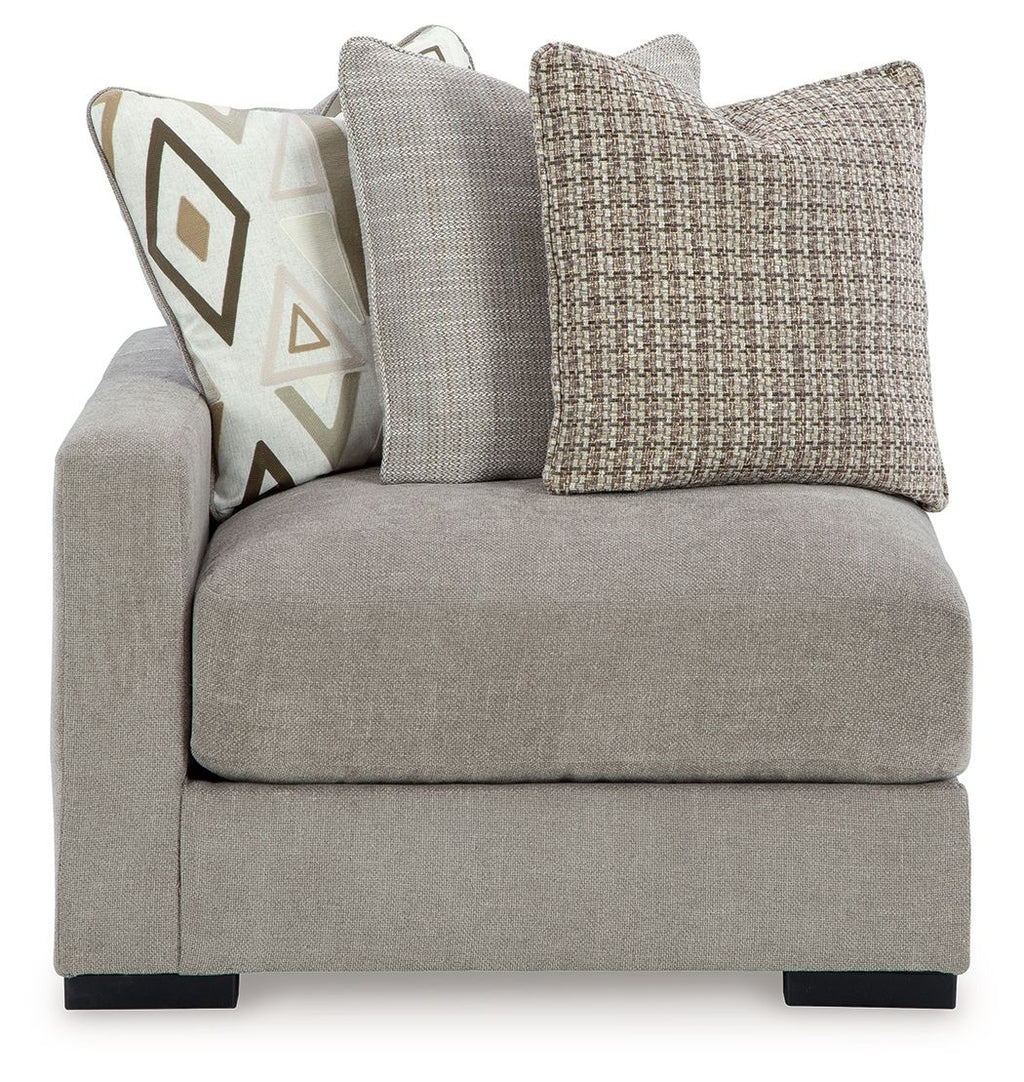 Pebble gray corner chair with tall backrest and textured fabric throw pillows