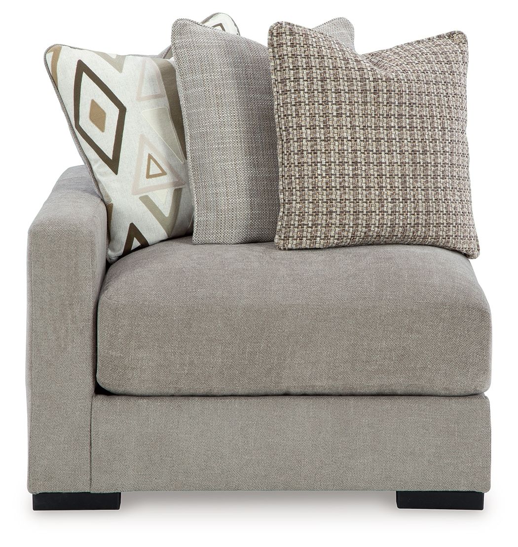 Pebble gray corner chair with tall backrest and textured fabric throw pillows