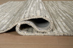 Gray rug with visible edge stitching and low pile rolled section