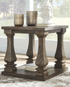 Rectangular end table with dark gray stained wood top and pedestal-style turned legs.