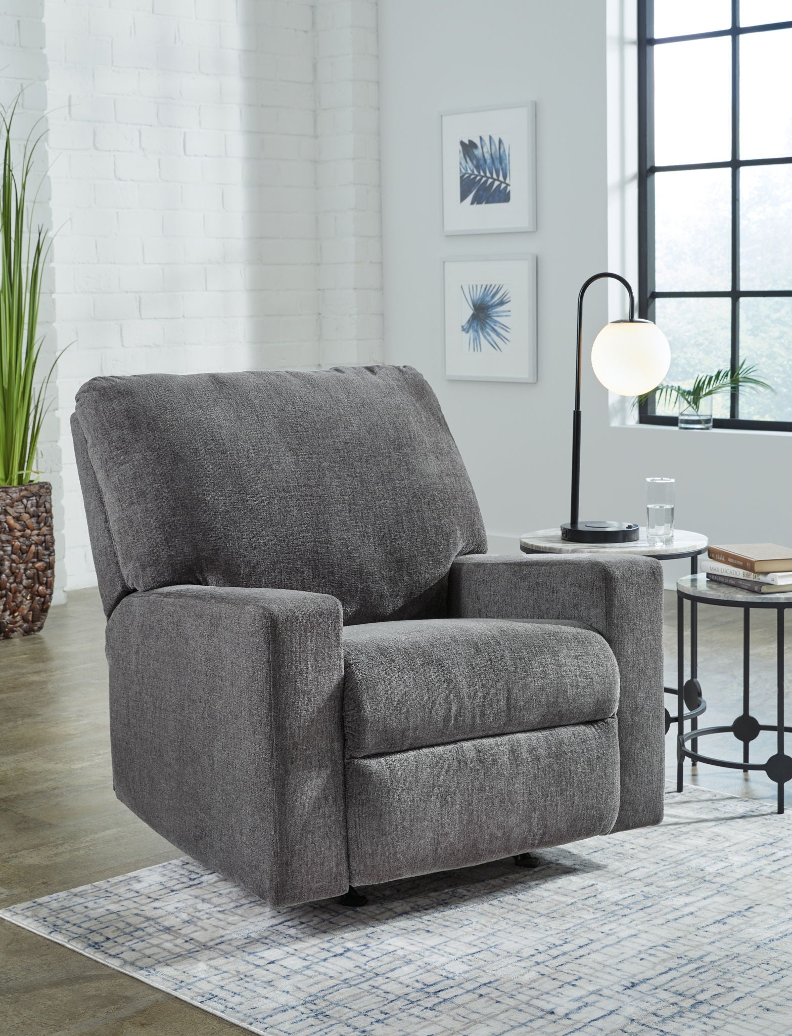 Pewter fabric rocker recliner chair, side profile with padded arms and footrest