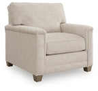 Upholstered accent chair in light beige fabric with rolled arms and cushioned seat
