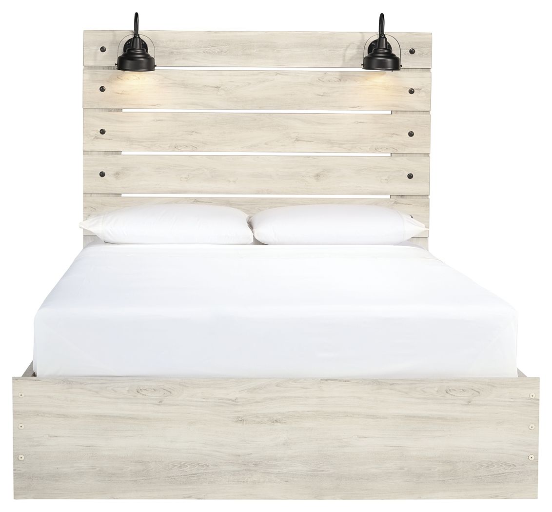 Light wood panel bed with two front drawers; white bedding and two black lamps on headboard
