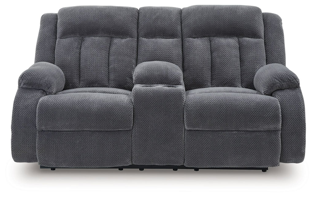 Dark gray double reclining loveseat with padded headrests and center console