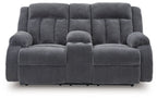 Dark gray double reclining loveseat with padded headrests and center console