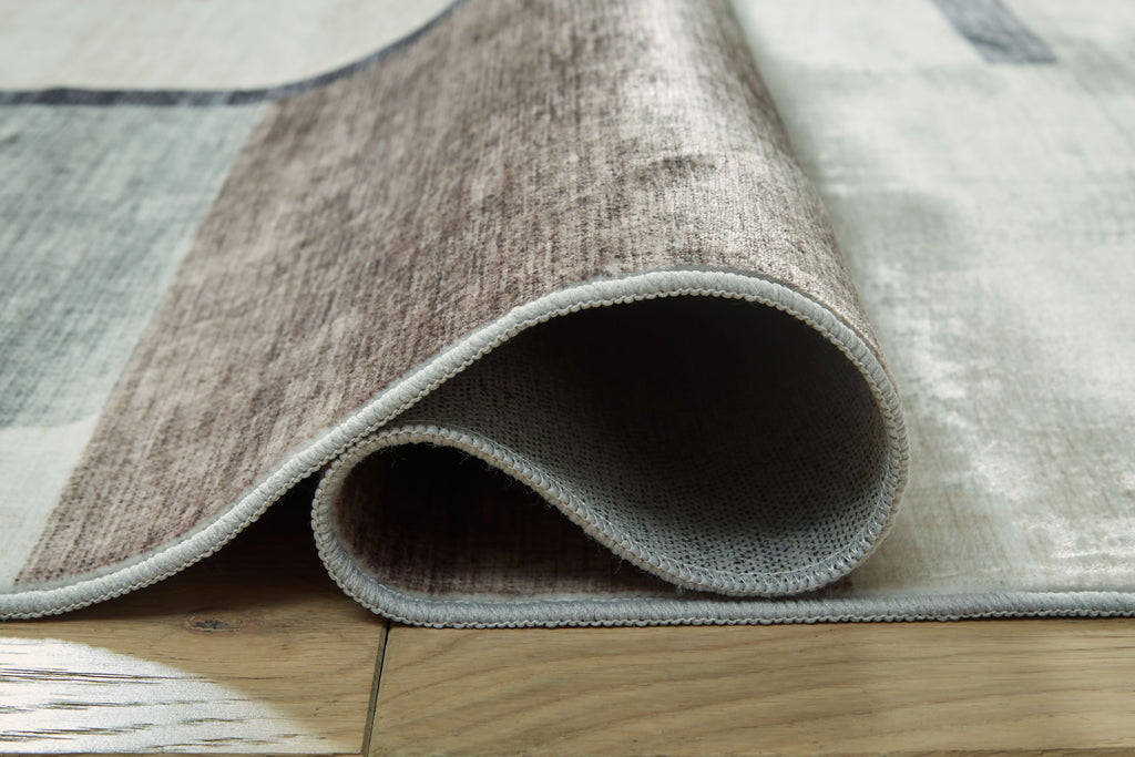 Beige & gray abstract washable rug with rolled edge and stitched border