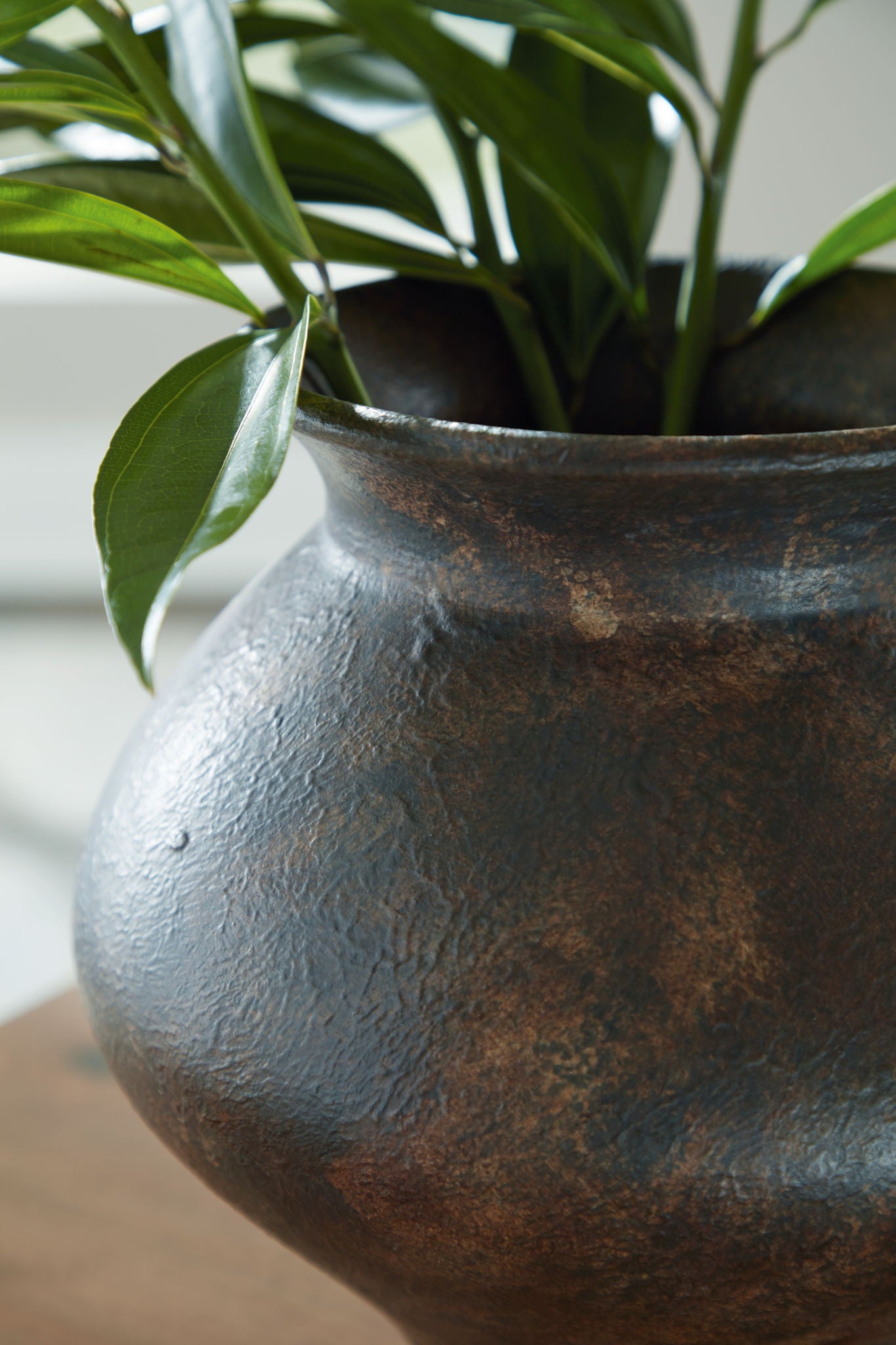 Antique brown vase close-up with mottled, textured finish and flared rim