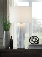 Poly table lamp featuring white drum shade and tall striped antique gray body