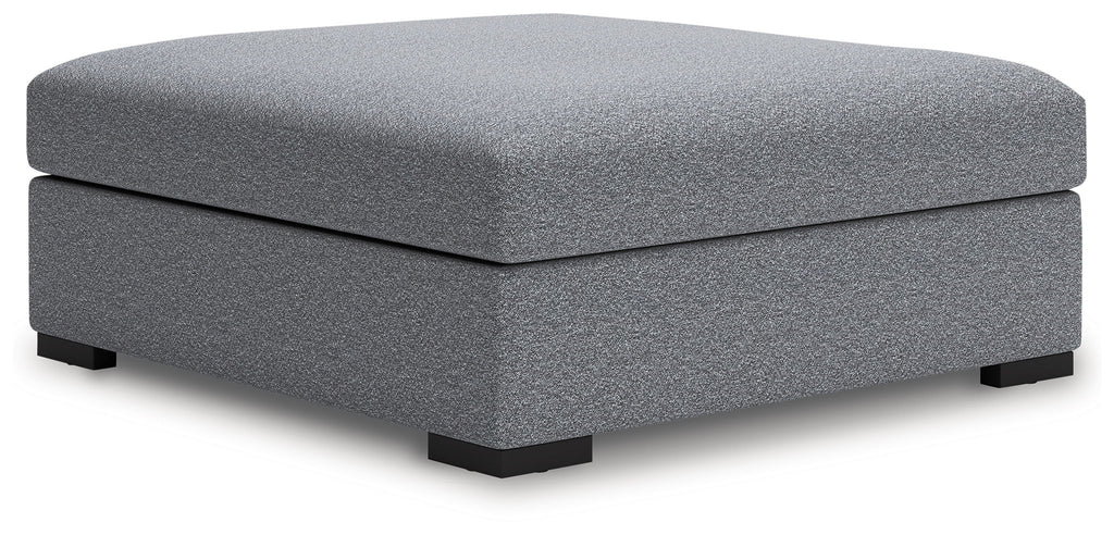 Oversized accent ottoman with rounded top in dark gray speckled fabric, low legs