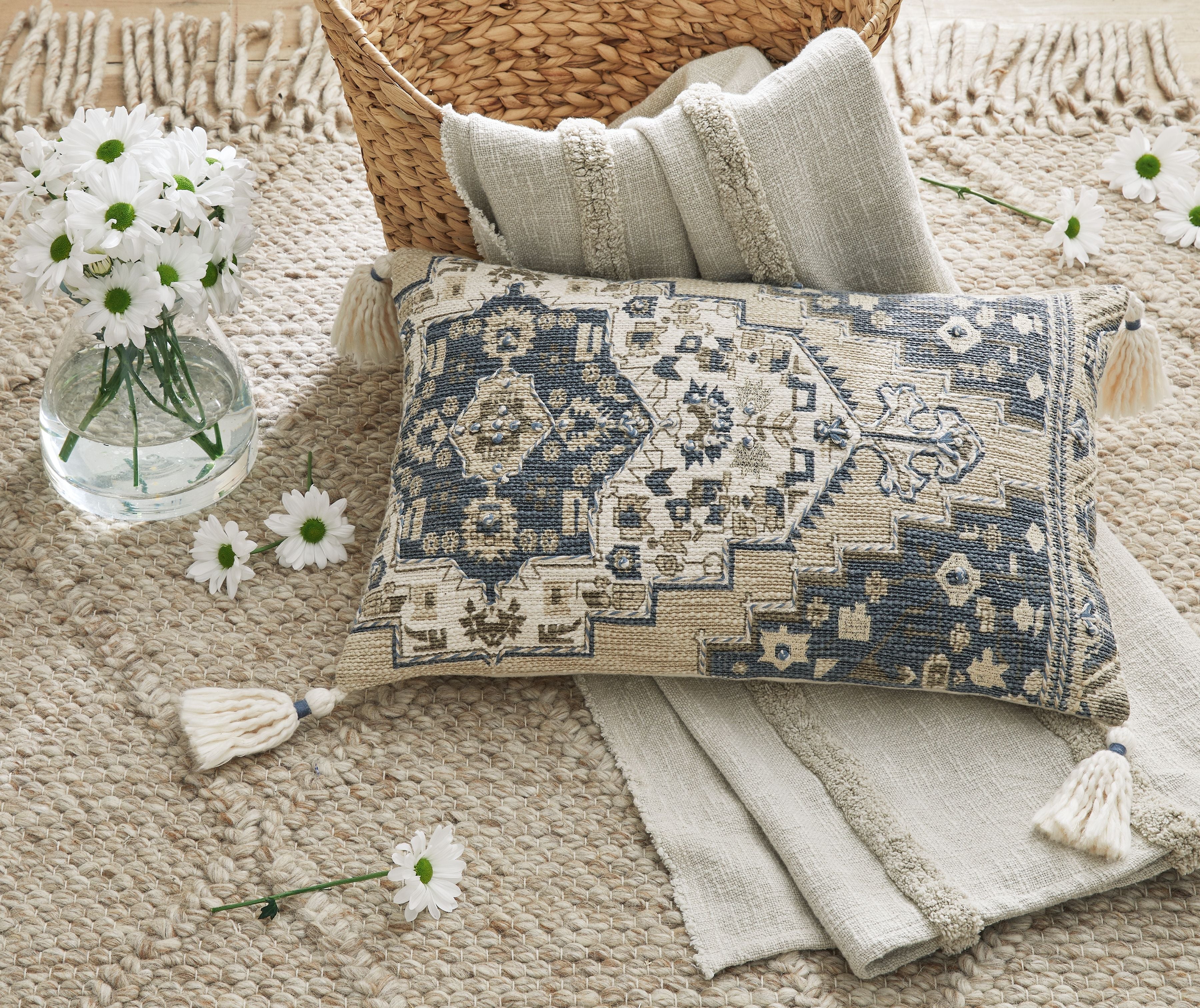 Geometric patterned lumbar pillow with white tassel trim, blue and cream
