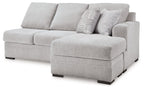 Light gray fabric sofa chaise with chaise ottoman and patterned lumbar pillow