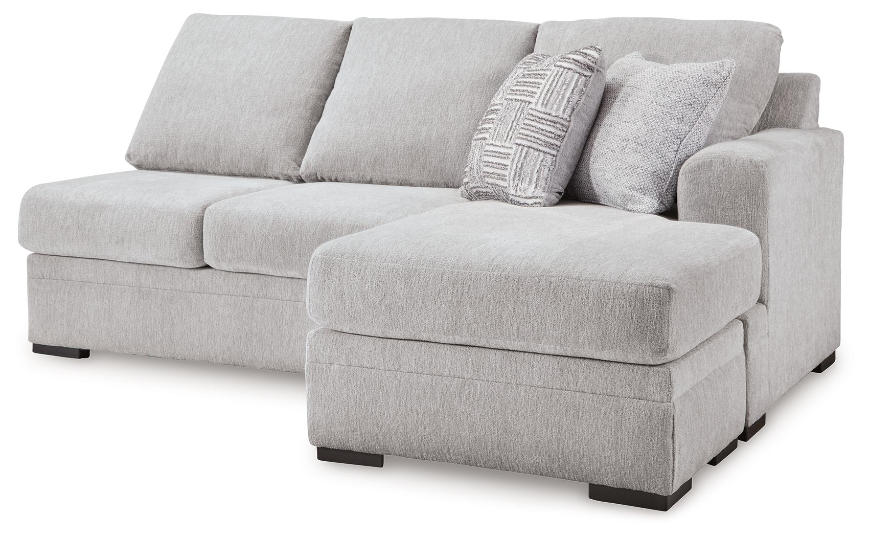 Light gray fabric sofa chaise with chaise ottoman and patterned lumbar pillow