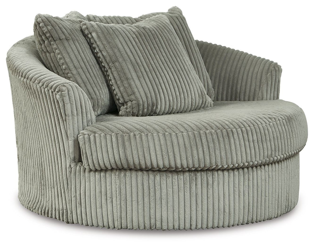 Gray oversized swivel accent chair in ribbed corduroy with three back pillows