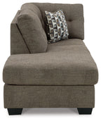 Corner chaise end seat with brown upholstery and patterned pillow