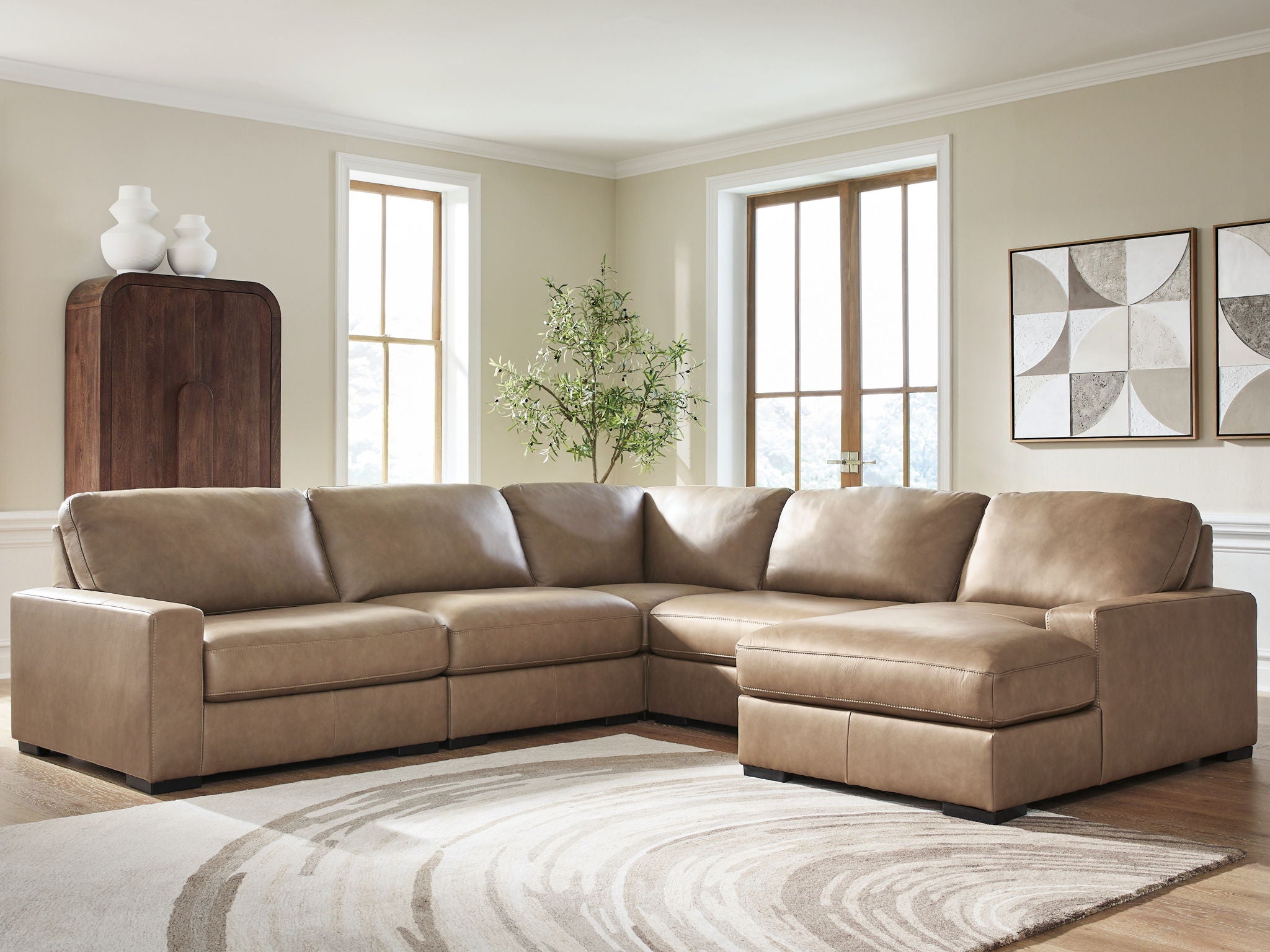 Sectional sofa in taupe fabric with square arms and cushioned back and seat sections